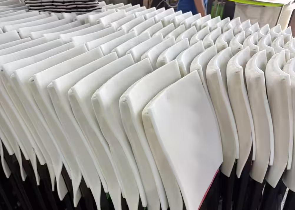 Upholstered chair frames lined up on an Asia furniture production line